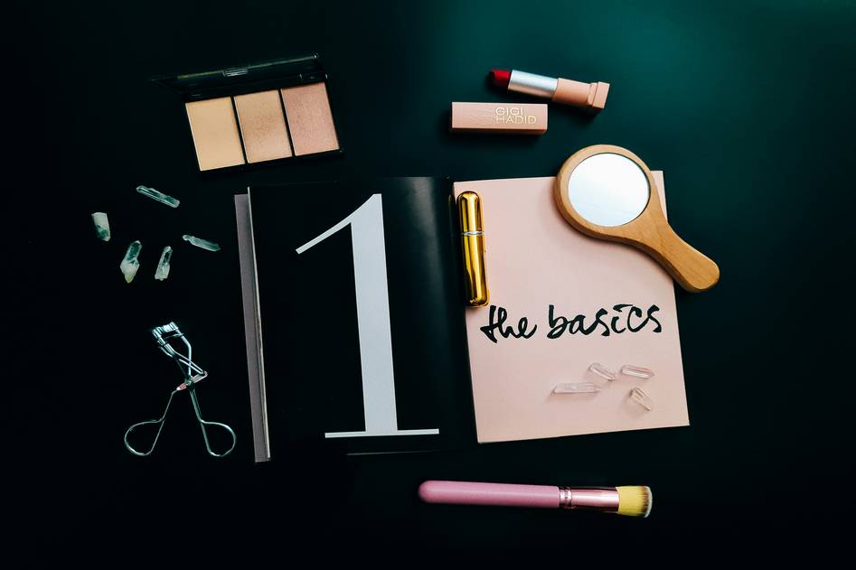 A close-up of beautifully tinted eyebrows with tinting tools and products arranged nearby